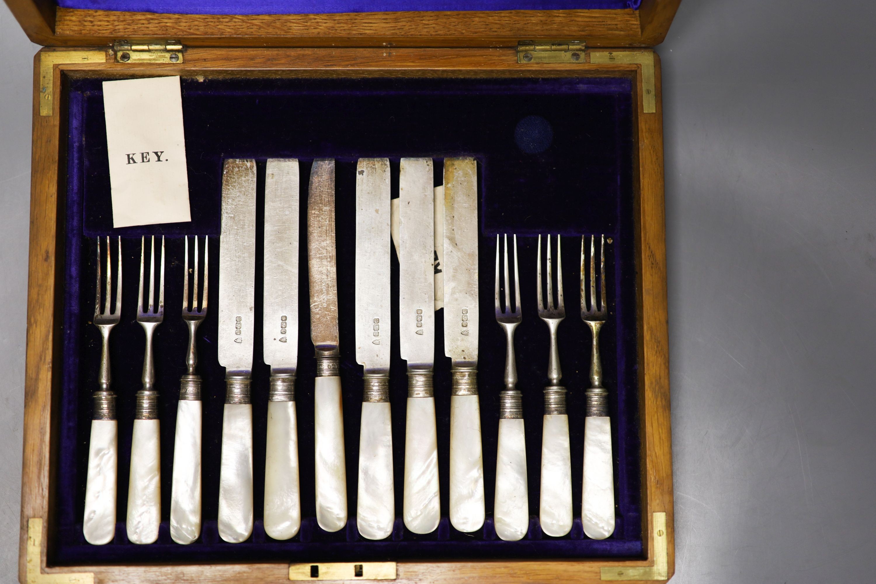 A George V cased set of six pairs of mother of pearl handled silver dessert eaters, Sheffield, 1912 and a plated part set.